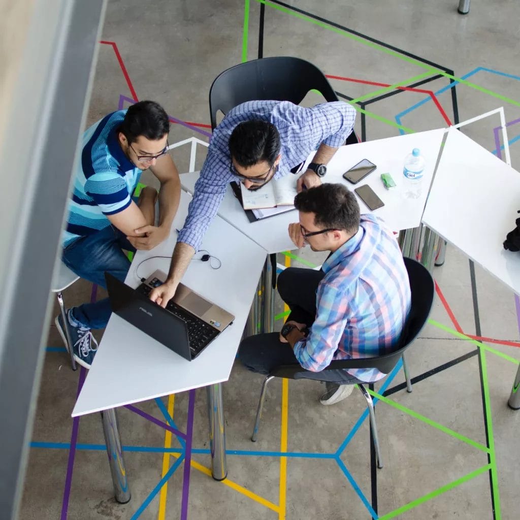 Indiegame marketing - Networking with peers - Photo by Visual Tag Mx on Pexels.com - A group of people discussing indie game marketing strategies around a table in an office.