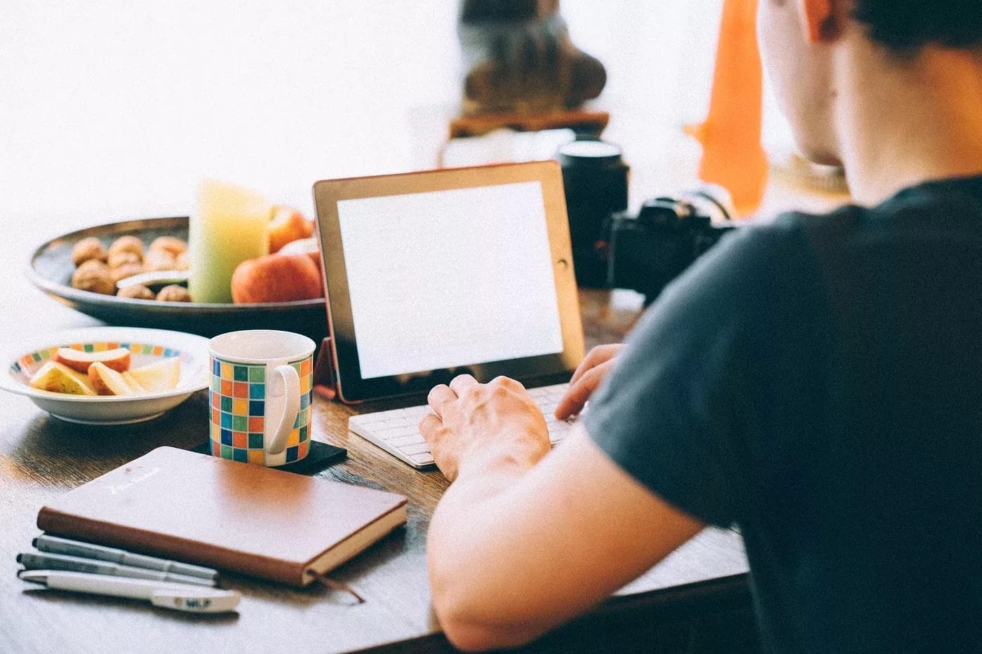 A man sitting at a desk with a laptop and a cup of coffee, timing, marketing strategy.