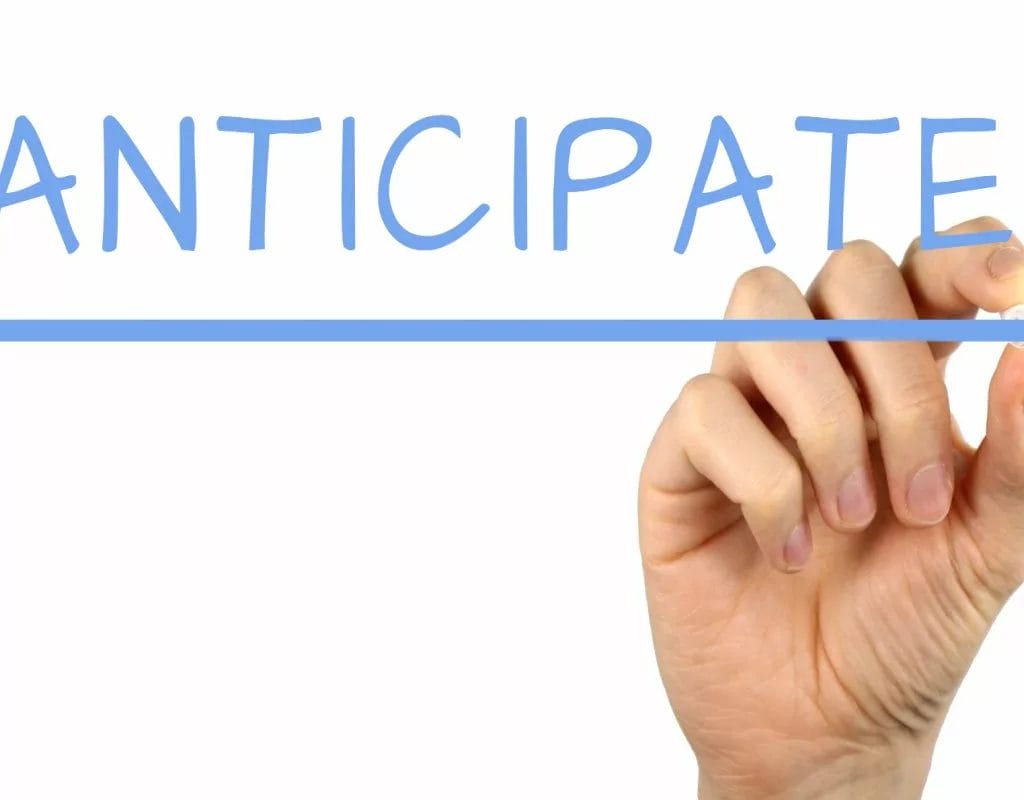 When is the best Time to begin Promoting Your Indie Game - Building Anticipation Closer to Release - A hand writing the word anticipate on a white board with a focus on promoting your indie game.