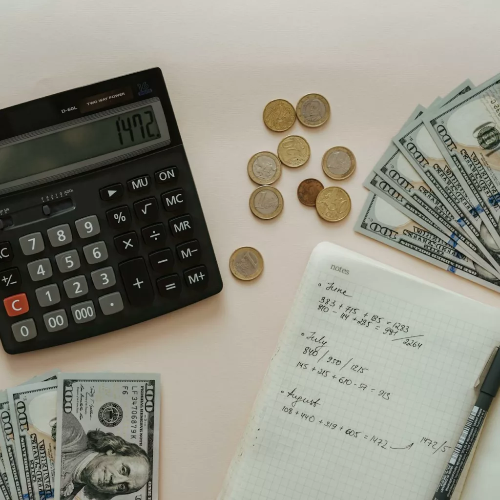 A notebook and money on a white background.