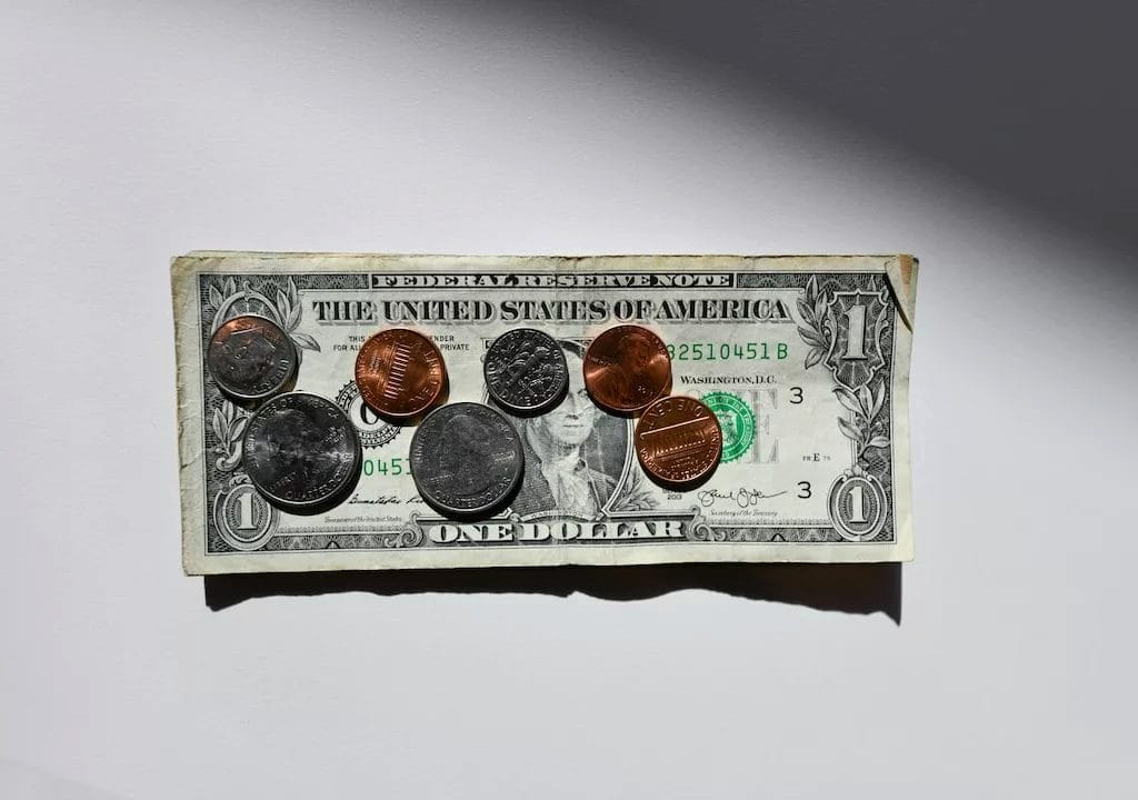 An Indie Game featuring a dollar bill adorned with pennies, quarters, and nickels while providing Smart Finance Tips and Budgeting strategies.