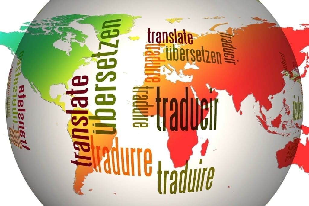 Finding the right name for your game - Translation and localization -- A globe with the word "translate" in multiple languages and fonts, overlaid on the world map in red, green, orange, and blue tones—perfect for finding the right name for your game across cultures.