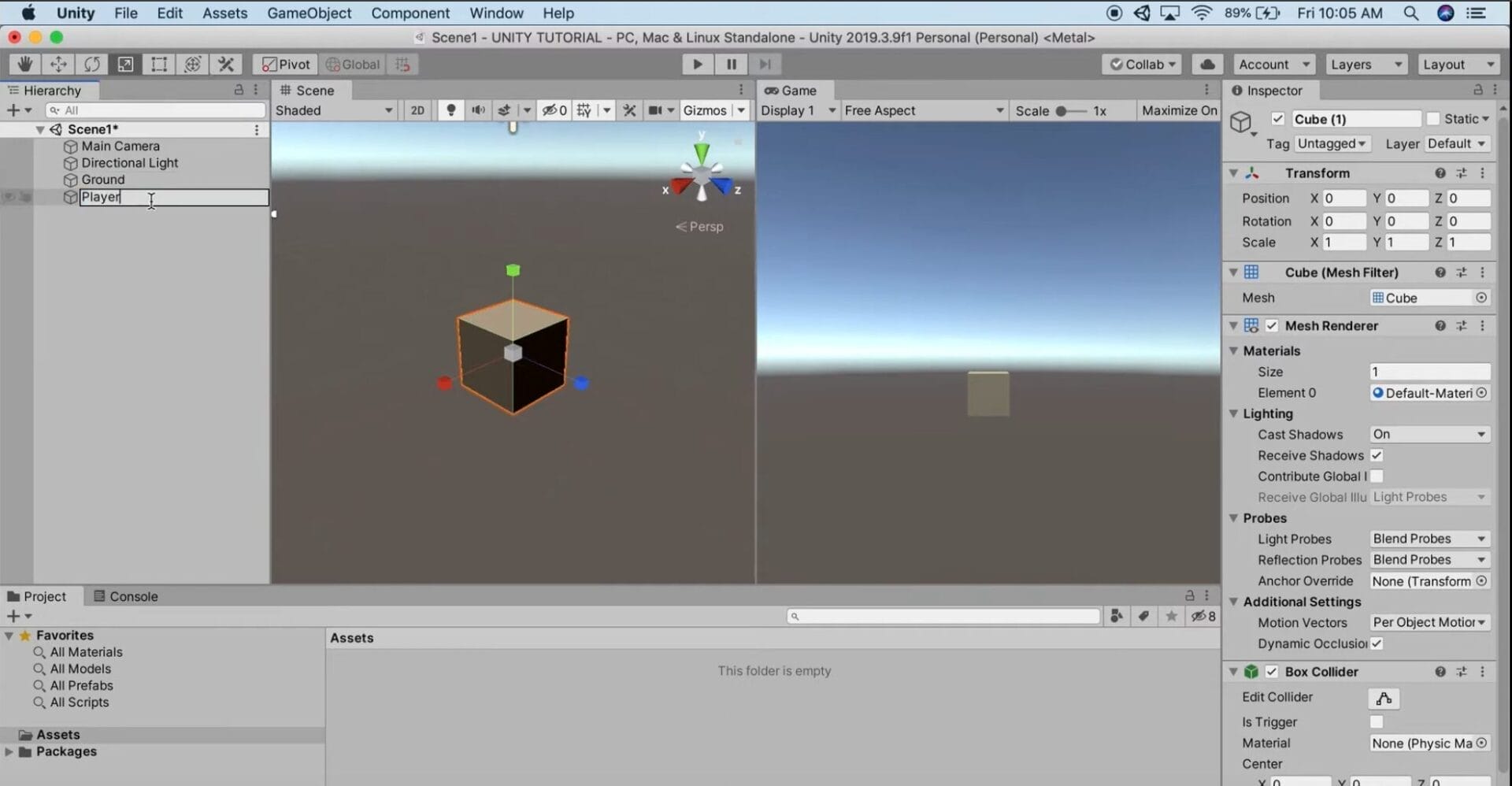 Player movement in Unity with Rigidbodies - Create Player Unity editor interface displaying a 3D scene with a central cube; both the scene and game views are visible, and the assets panel is empty—ideal for experimenting with player movement in Unity with Rigidbodies.