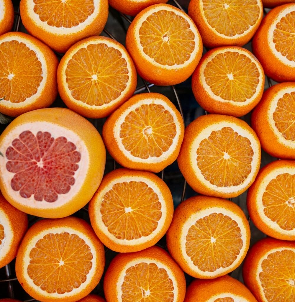 Finding the right name for your game - Photo by S Pexels.com A group of sliced oranges arranged closely together, with one sliced grapefruit among them—much like finding the right name for your game among countless choices.