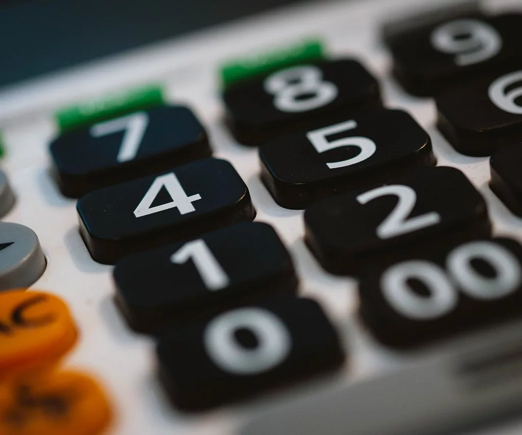 A close up of a calculator displaying numbers, offering smart finance tips for indie game budgeting.